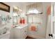 Well-lit bathroom featuring a single sink vanity, medicine cabinet and colorful window curtains at 18 Fernandina St, Mount Pleasant, SC 29464
