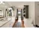 Bright bathroom featuring double vanity, wood floors, an enclosed water closet and outdoor access at 18 Fernandina St, Mount Pleasant, SC 29464
