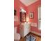 Bright pink bathroom featuring white fixtures, fun zebra rug, and framed botanical prints on the walls at 18 Fernandina St, Mount Pleasant, SC 29464