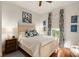 Bright bedroom with white bedding, blue accents, and hardwood floors provides a peaceful retreat at 18 Fernandina St, Mount Pleasant, SC 29464
