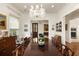 Formal dining room with a large wooden table, chandelier, and view to the front entry at 18 Fernandina St, Mount Pleasant, SC 29464