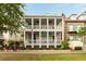 Stunning two-story home features a spacious double porch, complete with columns and ceiling fans at 18 Fernandina St, Mount Pleasant, SC 29464
