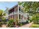 Elegant multi-story home with large porches, plantation shutters, and landscaped yard at 18 Fernandina St, Mount Pleasant, SC 29464