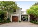 Charming home featuring a wooden garage door, covered parking, and a balcony at 18 Fernandina St, Mount Pleasant, SC 29464