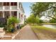 Beautiful home exterior featuring a walkway near a pond and lush greenery at 18 Fernandina St, Mount Pleasant, SC 29464