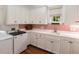 Well-organized laundry room with white cabinets, countertops, and modern appliances at 18 Fernandina St, Mount Pleasant, SC 29464