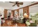 Cozy living room with natural lighting, wood paneling, and a ceiling fan that is perfect for relaxation at 18 Fernandina St, Mount Pleasant, SC 29464