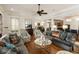Open-concept living room with hardwood floors, neutral furniture, and a ceiling fan at 18 Fernandina St, Mount Pleasant, SC 29464
