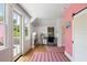 Bright office space with hardwood floors, a modern desk and a window with access to a private balcony at 18 Fernandina St, Mount Pleasant, SC 29464