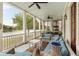 Relaxing porch with ceiling fans and comfortable seating, overlooking the serene lake at 18 Fernandina St, Mount Pleasant, SC 29464