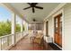 Spacious covered porch featuring wood floors, seating, ceiling fans and scenic views at 18 Fernandina St, Mount Pleasant, SC 29464