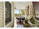 Inviting porch with waterfront views, ceiling fans, and outdoor dining area at 18 Fernandina St, Mount Pleasant, SC 29464