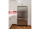 Stainless steel refrigerator is set among white cabinets and matching hardware at 18 Fernandina St, Mount Pleasant, SC 29464