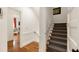 Hallway with carpeted stairway and view into a cozy living area with hardwood floors at 18 Fernandina St, Mount Pleasant, SC 29464