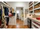 Organized walk-in closet with custom shelving, hanging racks, storage, and built-in desk at 18 Fernandina St, Mount Pleasant, SC 29464