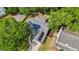 An aerial view of a home with solar panels, surrounded by lush trees at 1939 Oak Tree Ln, Mount Pleasant, SC 29464