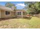 Inviting backyard featuring well-maintained lawn, mature trees, and a charming picnic table area for outdoor relaxation at 1939 Oak Tree Ln, Mount Pleasant, SC 29464