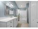 Well-lit bathroom featuring a double vanity sink and shower/tub combo at 1939 Oak Tree Ln, Mount Pleasant, SC 29464