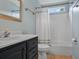Well-lit bathroom with a black vanity, white sink, and a shower-tub combo at 1939 Oak Tree Ln, Mount Pleasant, SC 29464