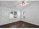 Bright bedroom featuring multiple windows, ceiling fan, and sleek wood flooring at 1939 Oak Tree Ln, Mount Pleasant, SC 29464