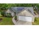 Aerial view of a single-Gathering home highlighting the solar panels, landscaping, and two-car garage at 1939 Oak Tree Ln, Mount Pleasant, SC 29464