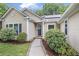 Close up of single-Gathering home featuring lush landscaping, walkway, and charming front door at 1939 Oak Tree Ln, Mount Pleasant, SC 29464