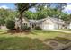 Single-Gathering home with large trees, and green grass creating a charming curb appeal at 1939 Oak Tree Ln, Mount Pleasant, SC 29464