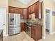 Well-equipped kitchen with stainless steel appliances, tiled flooring, and wood cabinetry at 1939 Oak Tree Ln, Mount Pleasant, SC 29464