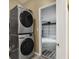 Modern laundry area with stacked washer and dryer next to garage access at 1939 Oak Tree Ln, Mount Pleasant, SC 29464