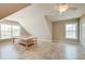Attic with vaulted ceiling, tiled floors, ample lighting and a workbench at 195 Highwoods Plantation Ave, Summerville, SC 29485