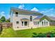 A spacious backyard with a well-maintained lawn and a charming two-story home at 195 Highwoods Plantation Ave, Summerville, SC 29485