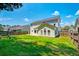 A spacious backyard with a well-maintained lawn and a charming two-story home at 195 Highwoods Plantation Ave, Summerville, SC 29485