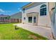 A home backyard featuring a concrete patio, grassy lawn, and privacy fence at 195 Highwoods Plantation Ave, Summerville, SC 29485