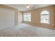 Bedroom featuring carpeted flooring, a ceiling fan, closet and arched window at 195 Highwoods Plantation Ave, Summerville, SC 29485