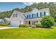 Charming two-story home featuring a well-manicured lawn, attached garage, and neutral siding at 195 Highwoods Plantation Ave, Summerville, SC 29485