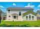 Rear exterior of a two-story home featuring a well-maintained lawn, concrete patio, and complementary architectural design at 195 Highwoods Plantation Ave, Summerville, SC 29485