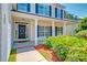Inviting front porch with classic columns, black front door, and fresh landscaping at 195 Highwoods Plantation Ave, Summerville, SC 29485