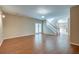 Open-concept living room with hardwood floors, staircase, and natural light from glass doors at 195 Highwoods Plantation Ave, Summerville, SC 29485