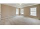 A spacious main bedroom with large windows and a ceiling fan at 195 Highwoods Plantation Ave, Summerville, SC 29485