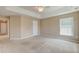 A spacious main bedroom with large windows and a ceiling fan at 195 Highwoods Plantation Ave, Summerville, SC 29485