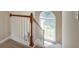 Carpeted staircase with wood railing and a large window offering natural light at 195 Highwoods Plantation Ave, Summerville, SC 29485