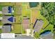 An aerial view reveals a home with a spacious lawn outlined by lot lines and a nearby pond at 203 Plowden Mill Ct, Summerville, SC 29485