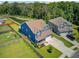 Aerial view of a home with a well-kept lawn, driveway, and fenced-in yard at 203 Plowden Mill Ct, Summerville, SC 29485