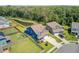 Overhead view of the property with a spacious yard, pond, and proximity to wooded area at 203 Plowden Mill Ct, Summerville, SC 29485