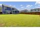 Expansive backyard featuring lush green lawn and a screened-in porch, perfect for outdoor gatherings at 203 Plowden Mill Ct, Summerville, SC 29485