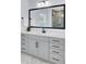 Bathroom vanity with a white countertop, modern black fixtures, and framed mirror enhancing the room's aesthetic at 203 Plowden Mill Ct, Summerville, SC 29485