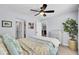 Cozy bedroom with ceiling fan, closet access, decorative dresser, and an artistic painting on the wall at 203 Plowden Mill Ct, Summerville, SC 29485