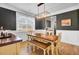 Staged dining room featuring a wooden table with stylish lighting and wainscoting at 203 Plowden Mill Ct, Summerville, SC 29485