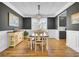 Stylish dining room featuring hardwood floors, wainscoting, and modern lighting at 203 Plowden Mill Ct, Summerville, SC 29485