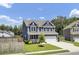 Charming two-story home features a manicured lawn, blue siding, and a two-car garage at 203 Plowden Mill Ct, Summerville, SC 29485